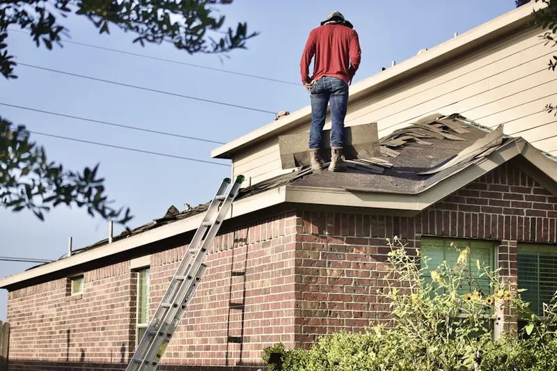 Professional roofer working on a residential roof in Snyder Crossing